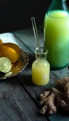 sliced lemon beside clear glass jar with green liquid